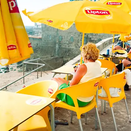 Yellow parasols and chairs at a cafe